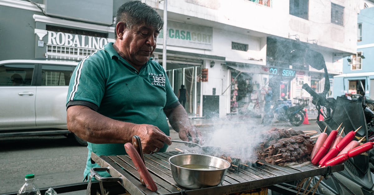 Anticucho street cart in Lima at night with skewers grilling over glowing coals and a line of local customers waiting