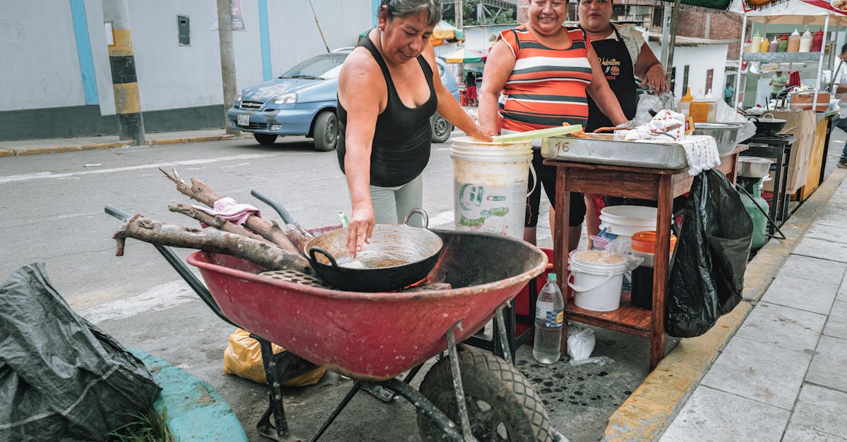 Busy Lima street food vendor with a line of local Peruvian customers, food being cooked fresh on the grill in front